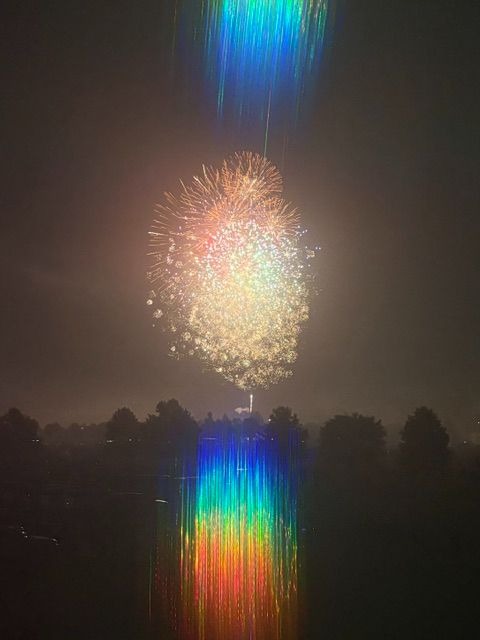 Rainbow effects of diffracted light as it surrounds a firework.  